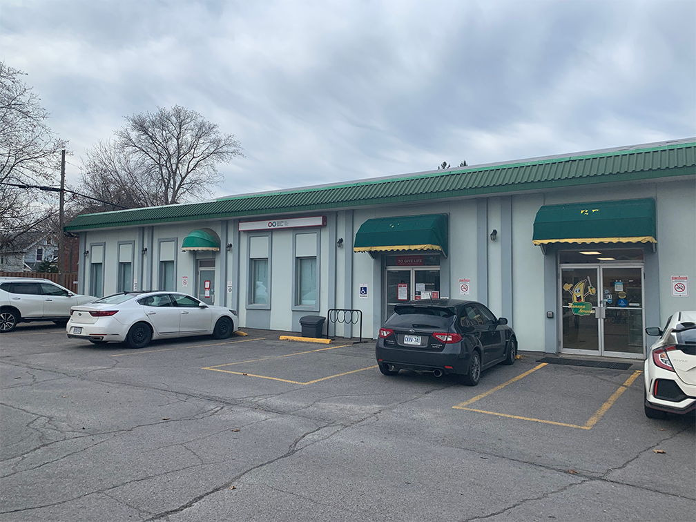 Image of Peterborough Donor Centre of the outside and the parking lot with light green walls