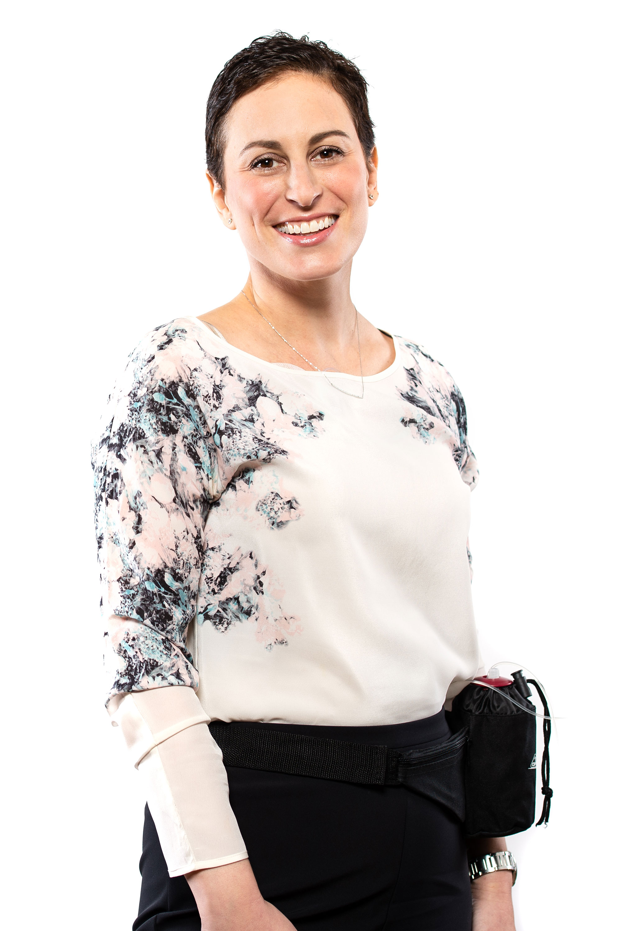 Person wearing a flowery shirt and black pants