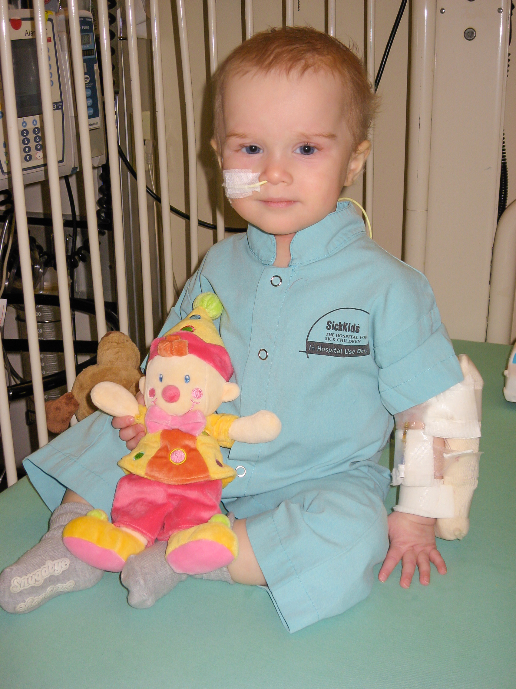 Image of Elsa Norton as a baby with a doll in the SickKids Hospital