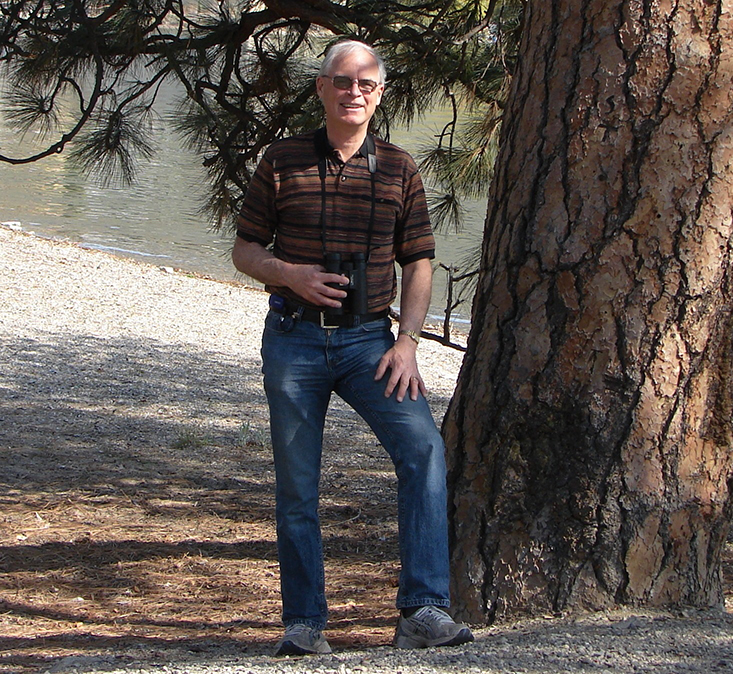 Blood donor standing next to a tree by lake shore