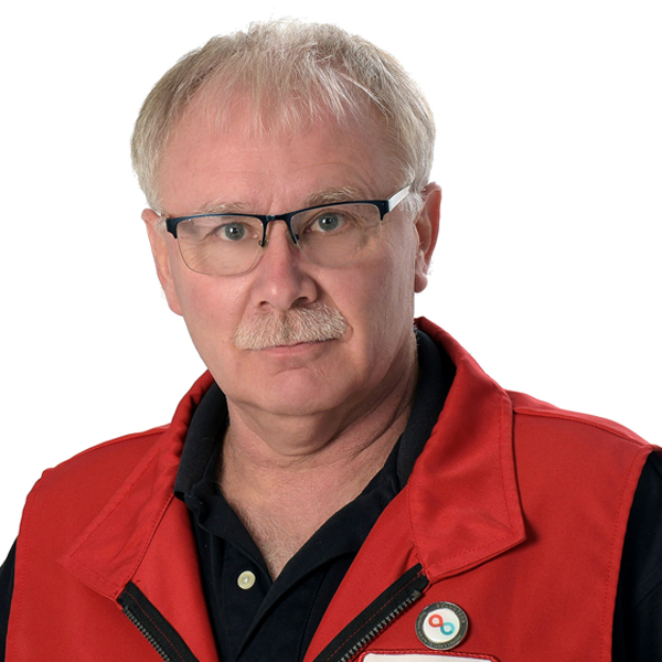 Photo of blood donor and volunteer Stephen Gregg with rectangular glasses and wearing a red Canadian Blood Services vest.