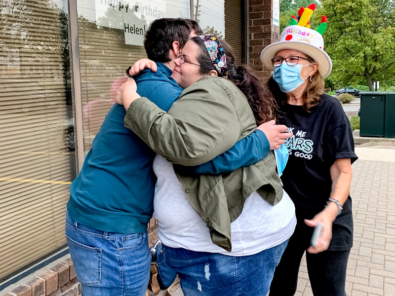 Image of Helen's daughter Allison Raymond hugging her son Sam Raymond after his first blood donation made at Helen Raymond's blood donor event