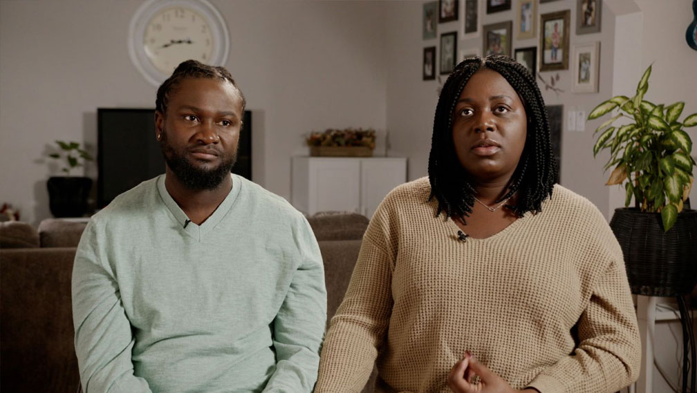 Couple sitting on a couch for an interview in a documentary