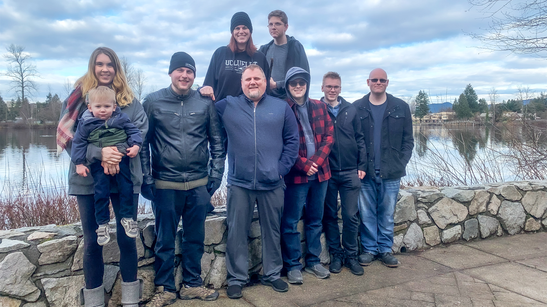 Image of blood recipient Nathan Olson standing at centre with his wife, five sons, daughter-in-law and grandson posing together outside