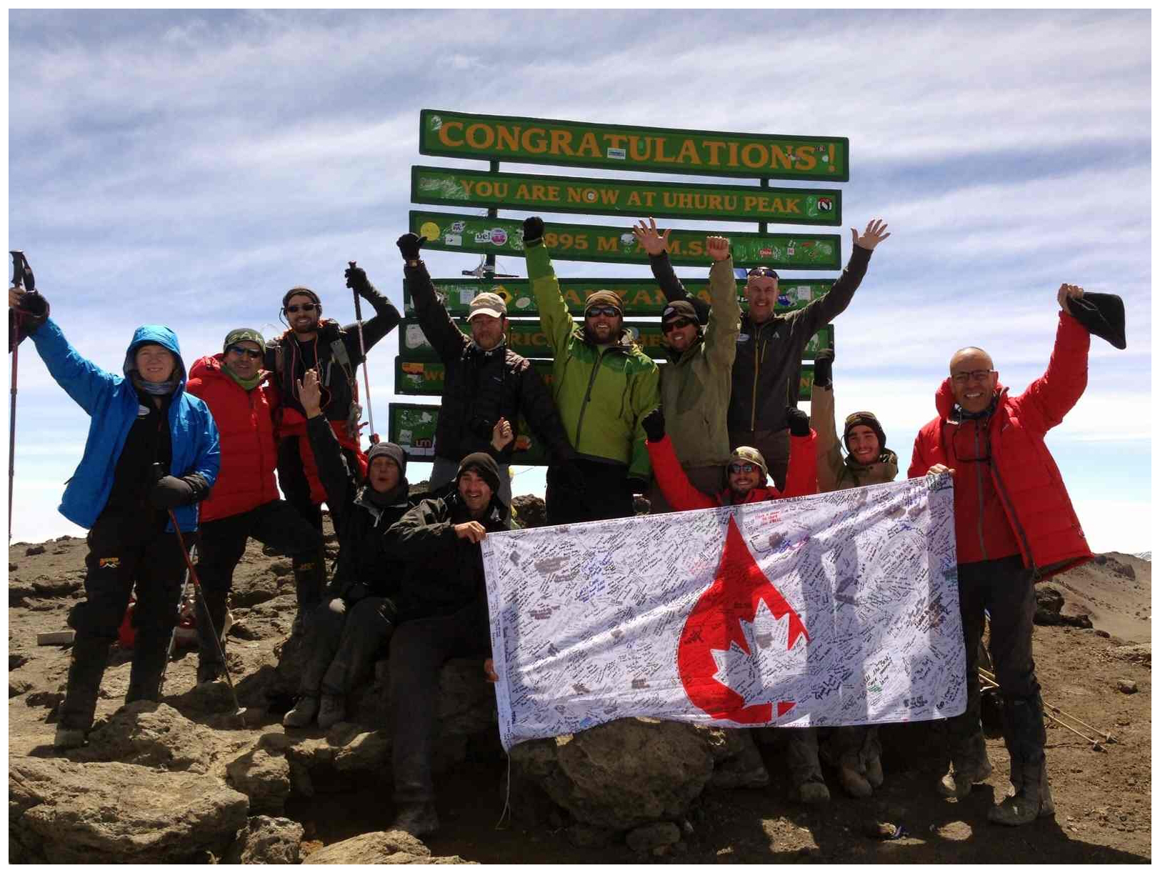 The climb team celebrates their trek at Mount Kilimanjaro