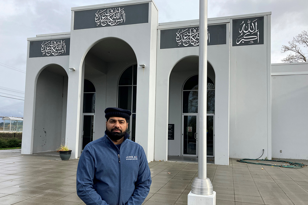 Adult man standing outside in front of a mosque