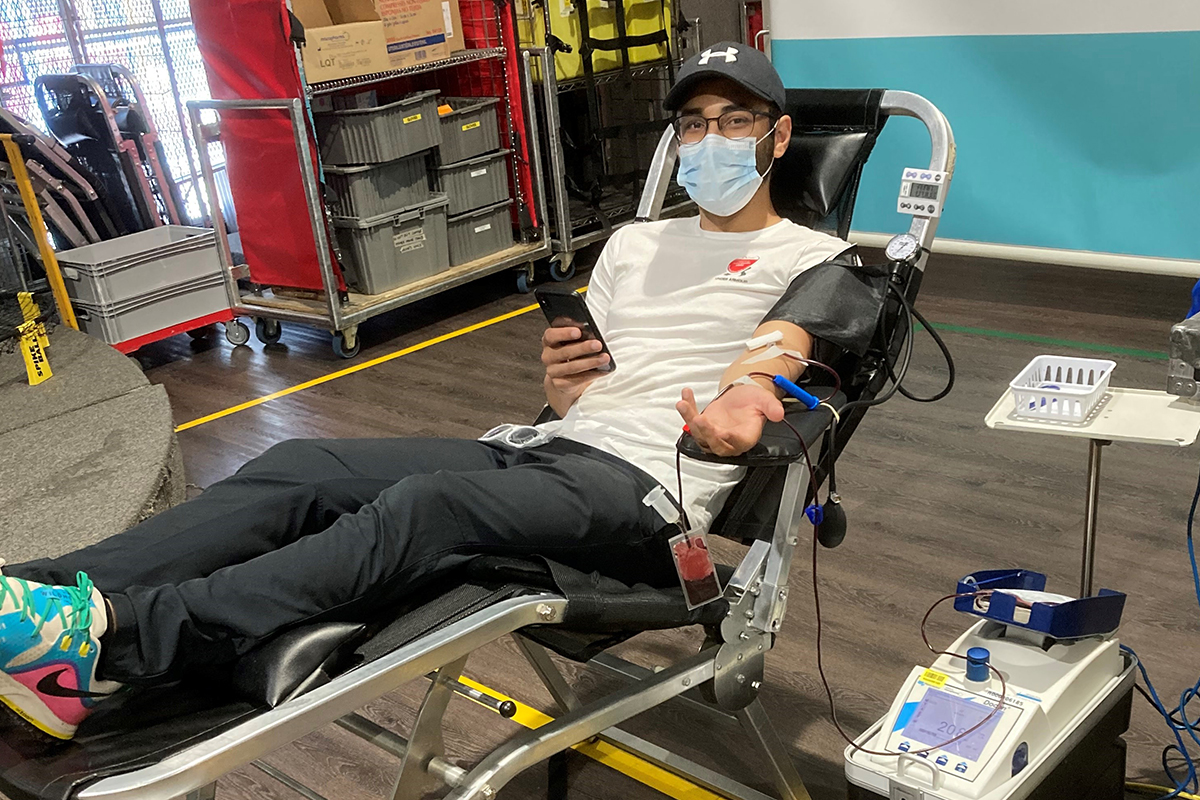 Man makes a blood donation laid back in a donor bed