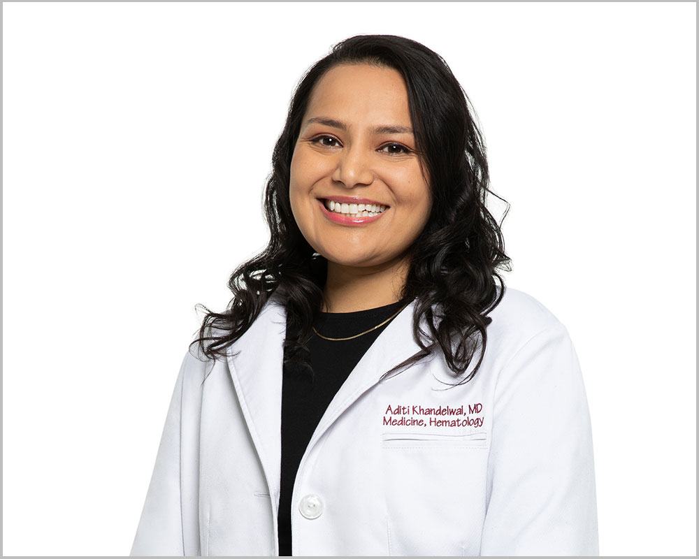 Physician in lab coat smiling