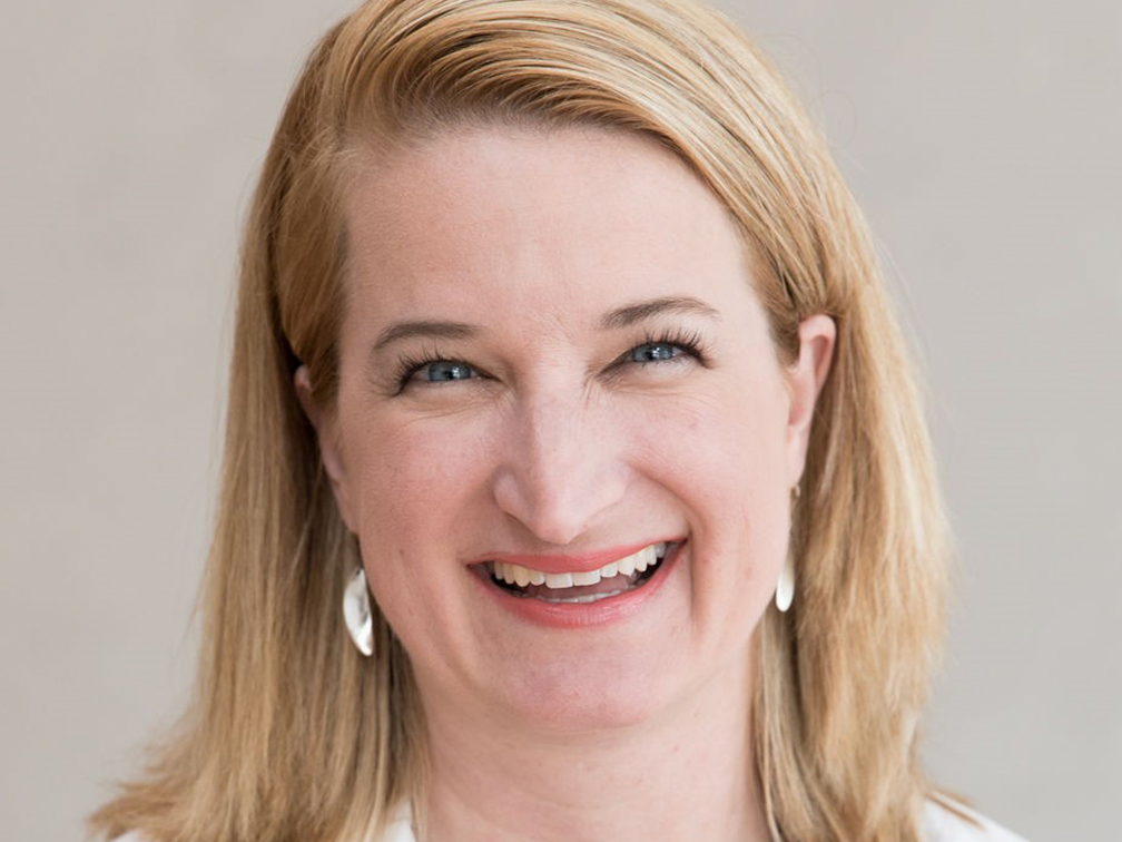 Dr Amy Waterman in lab coat smiling