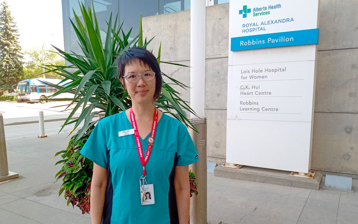 A cord blood specialist in scrubs on a hospital campus in Edmonton.