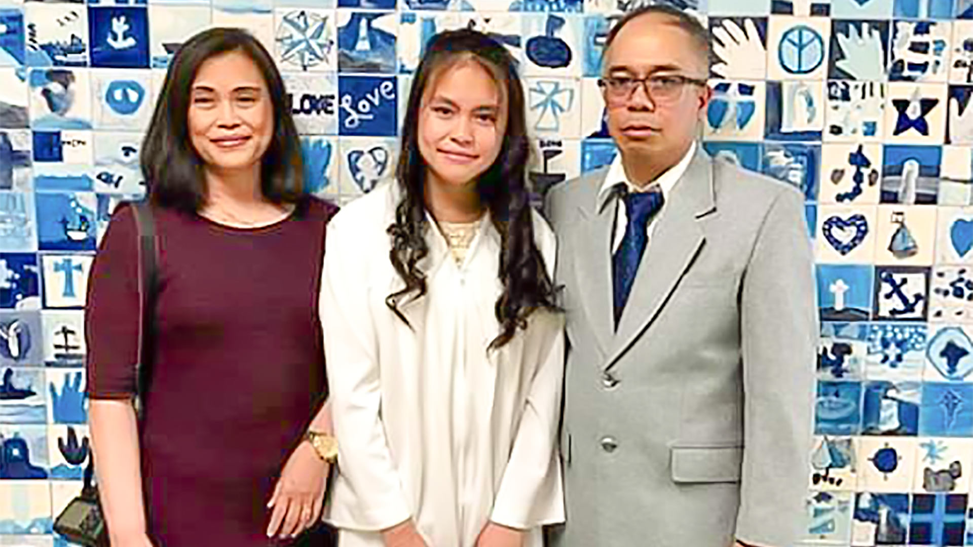 plasma transfusion recipient Paula in a white dress stands between her mother and father