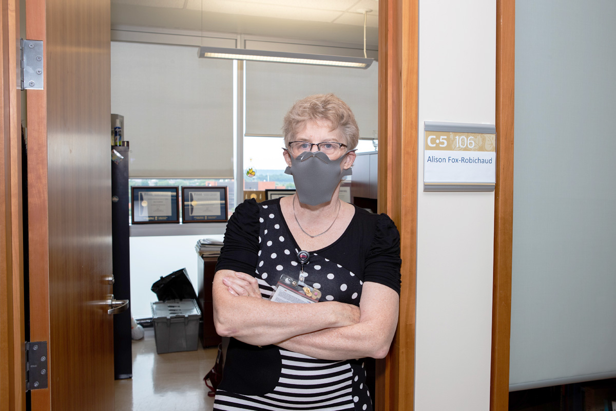 Dr. Alison Fox-Robichaud, a critical care physician, stands with her arms crossed