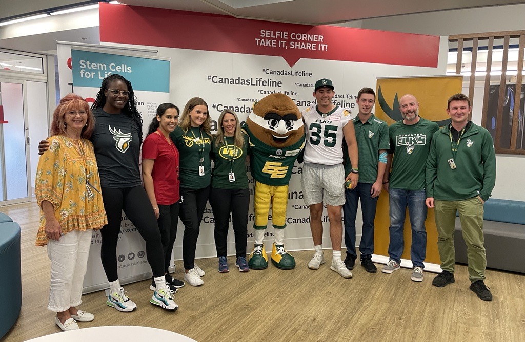 Group photo with Edmonton Elks coaching staff and quarterback