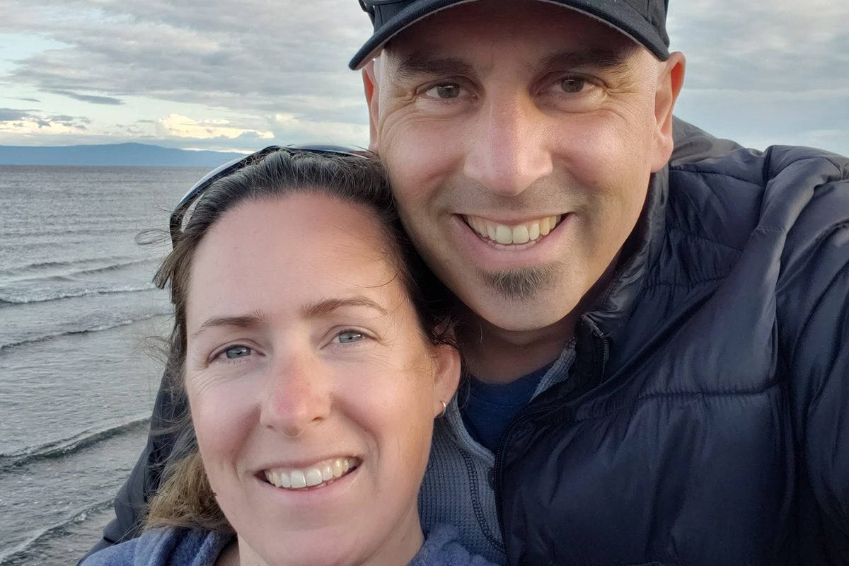 Stem cell recipient Greg Duerksen holds his wife by a beachside in Vancouver.