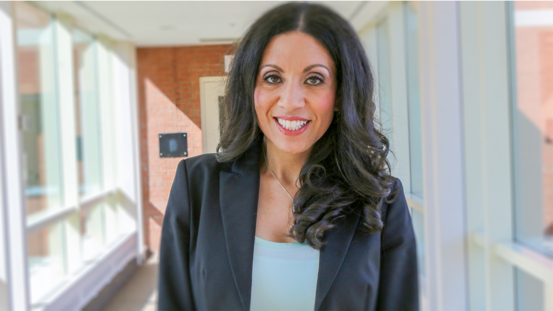 Image of director of stem cells Dr. Heidi Elmoazzen standing at the bridgeway at Canadian Blood Services Alta Vista office