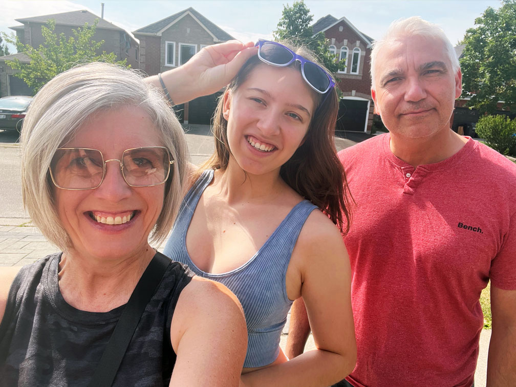 A young plasma recipient outside with her parents