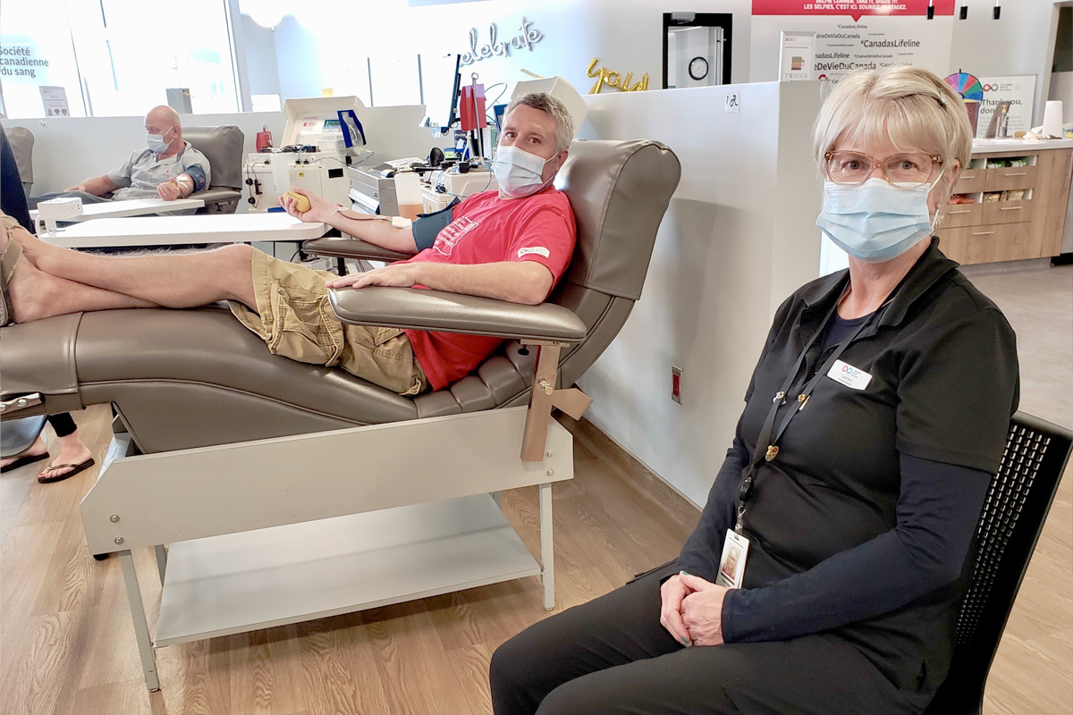 A man donating plasma and a registered nurse in a plasma donor centre in Sudbury, Ont.