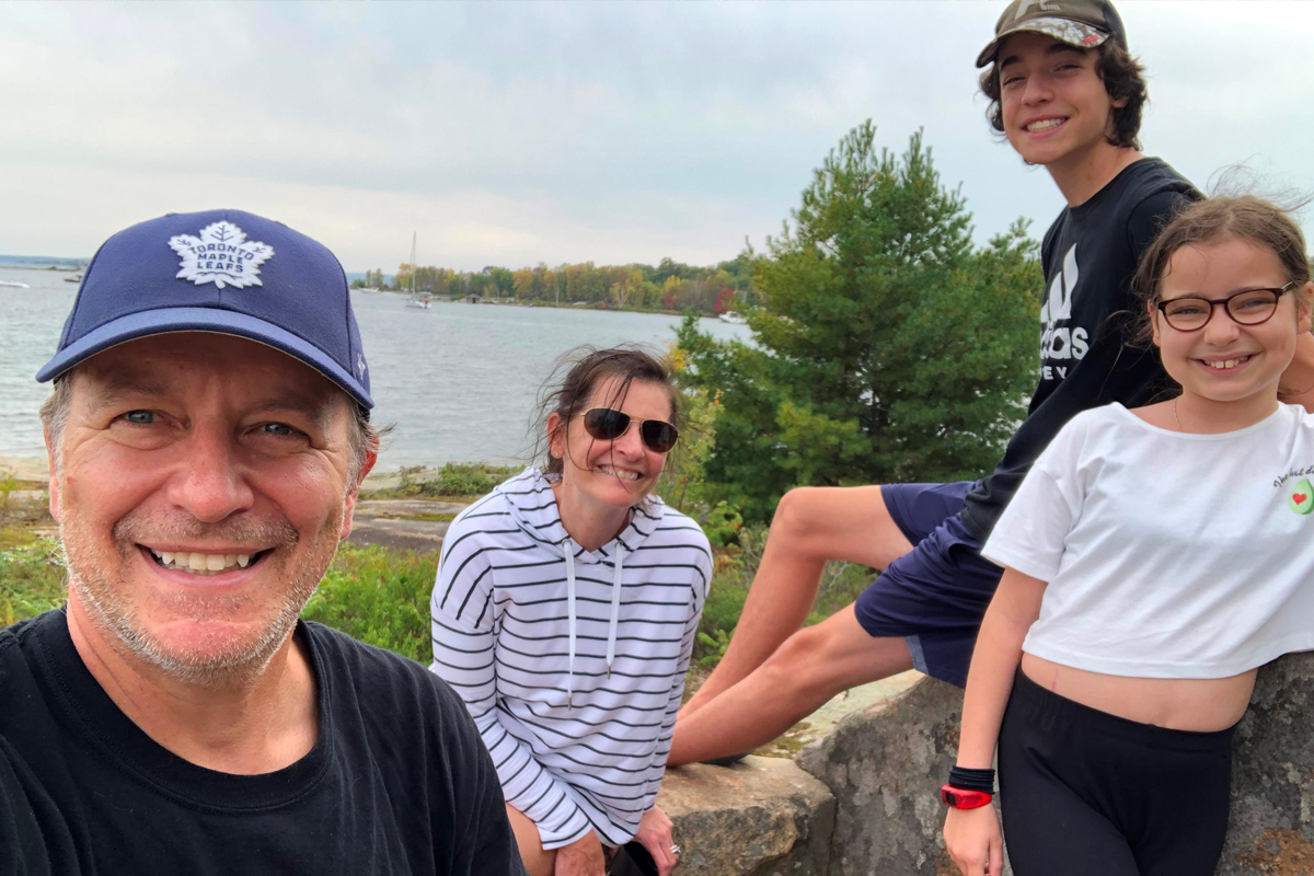 The Jolink family of four posing outside near a lake