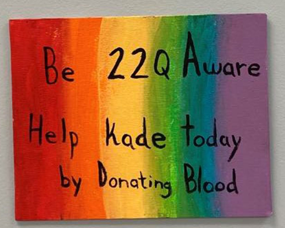 Rainbow coloured sign calling for blood donors