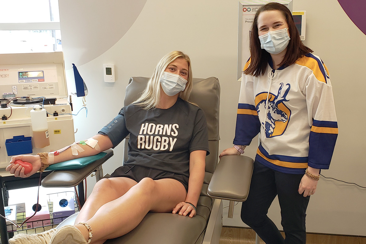 A student donating plasma at the Lethbridge plasma donor centre