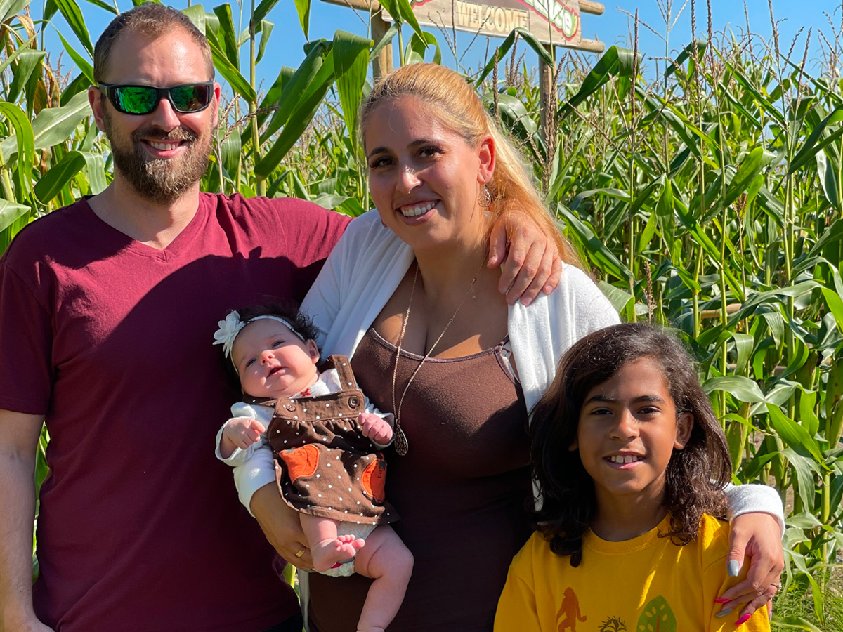 Cord blood donors Lena Mallary and Cory Greenhalgh pose with their baby and Lena’s son at a corn farm in B.C.