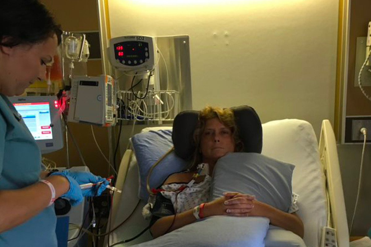 Image of a woman receiving plasma treatments lying in a hospital bed.