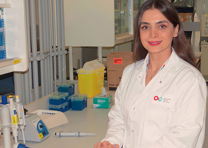 Mahsa Yazdanbakhsh in a white Canadian Blood Services lab coat