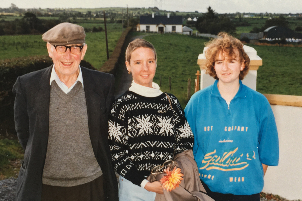 Cancer survivor Margaret Lynch stands with her grandfather and cousin at their farm in Ireland.