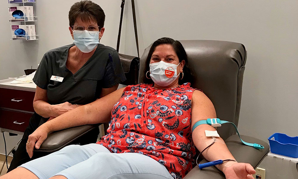 Blood donor in donation bed with an employee