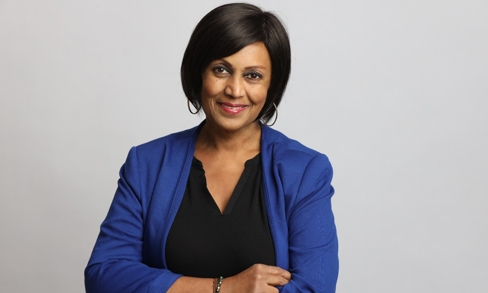 Munira Premji, author of Choosing Hope: 1 Woman. 3 Cancers smiles in a portrait.