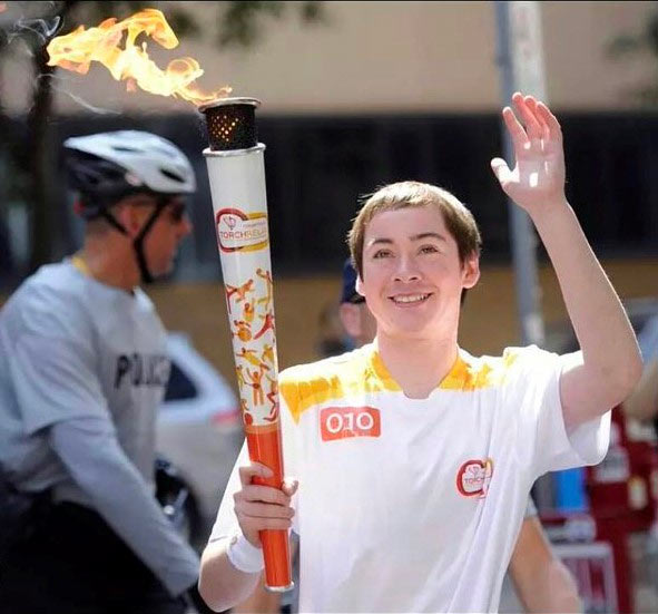Myles Lynch carrying touch as part of Pan am Games