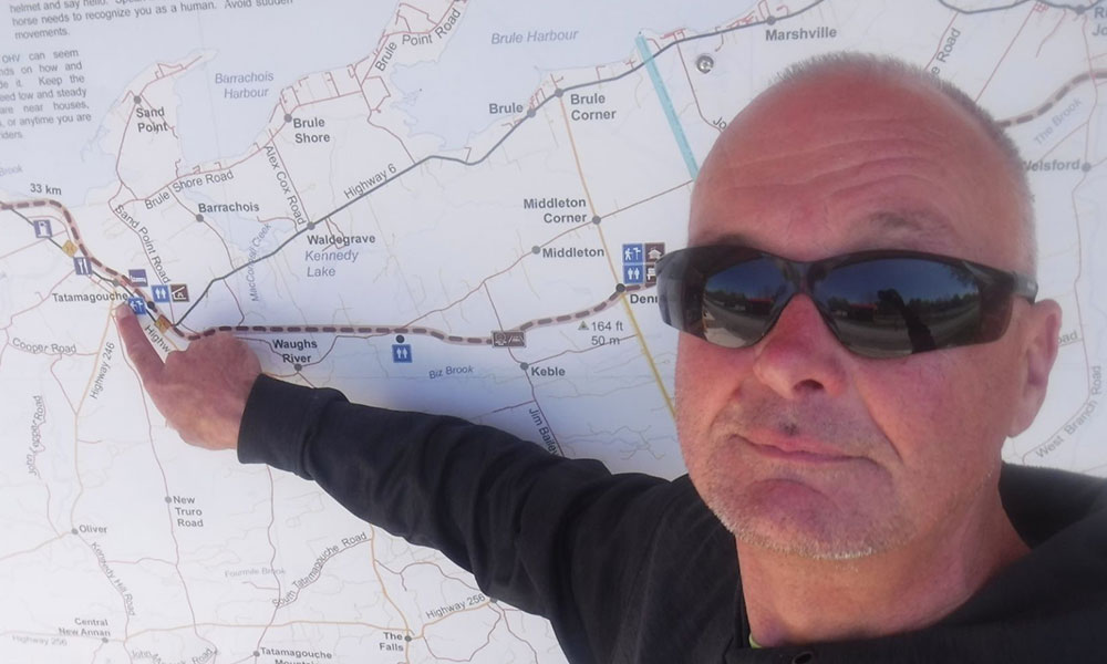 A man in front of a map