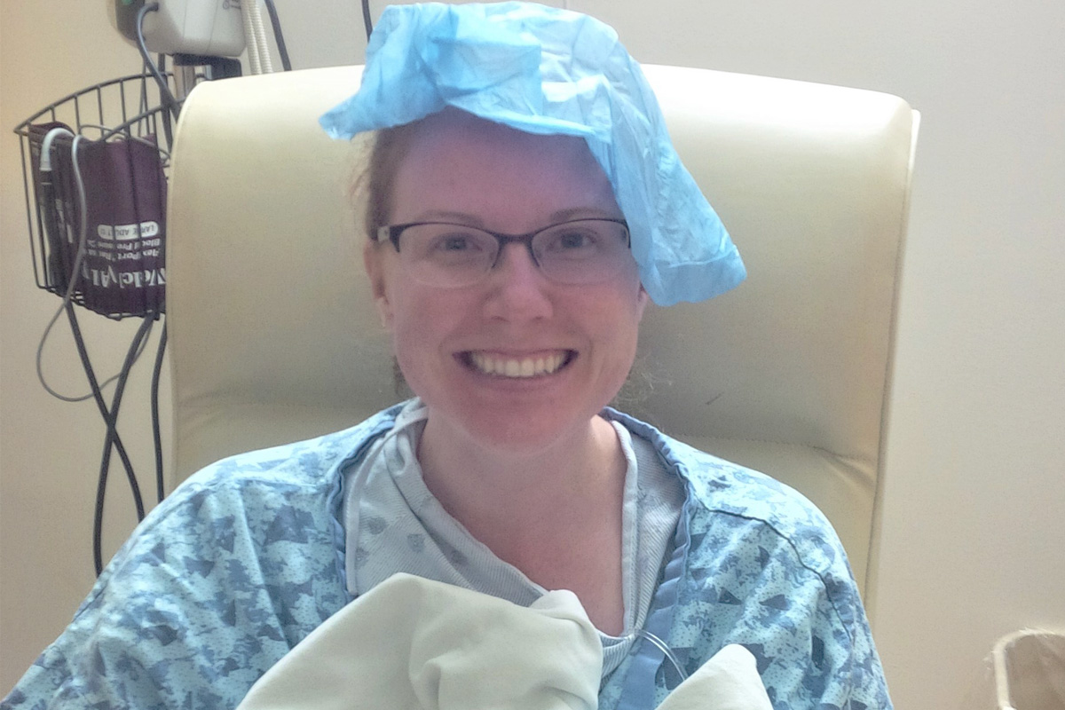 Rachel Van Pelt sits gleefully on a chair on the day of her stem cell donation.