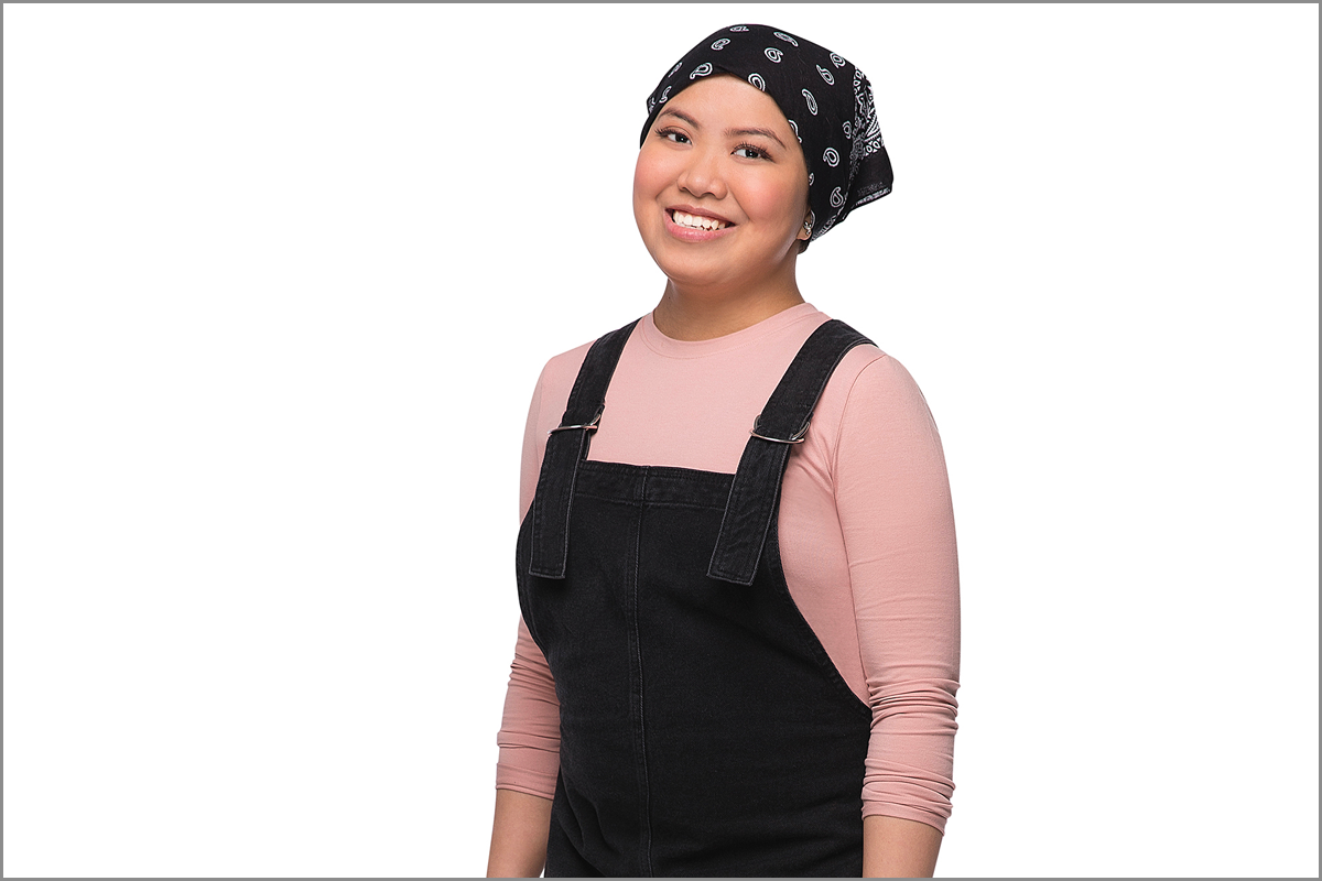 Roshlind smiles in front of a white background