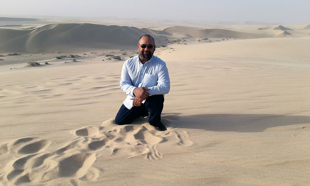 Man kneeling in desert