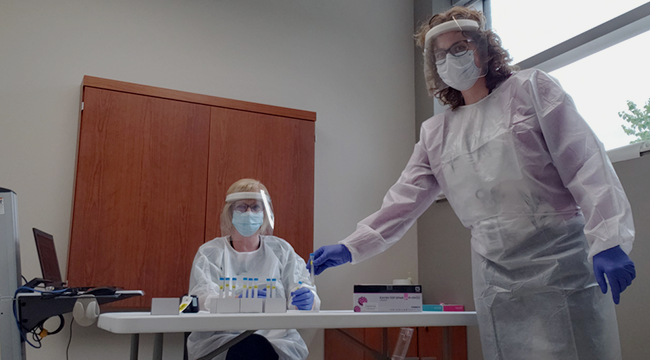 Michelle Rendell (standing) joins technical specialist Heather Goodwin in the room where rapid screening takes place in Dartmouth.