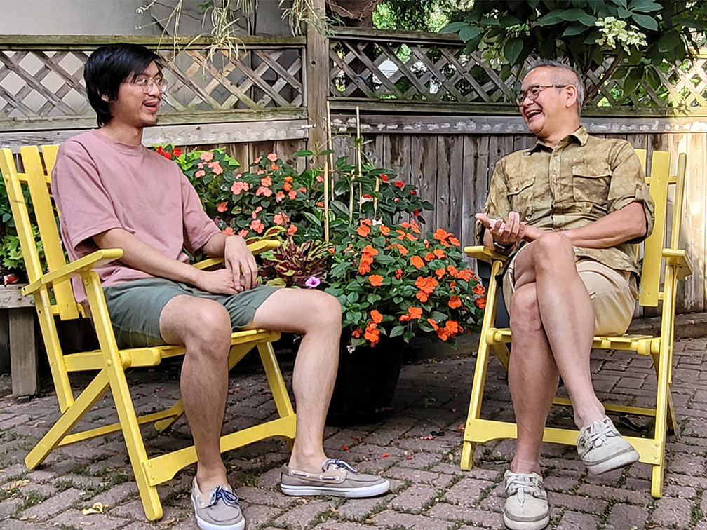 Father and son smiling in garden