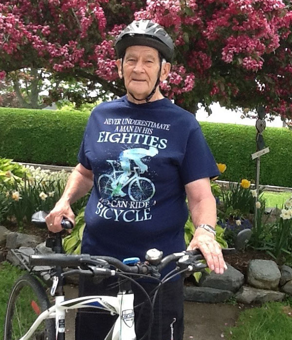 A man standing beside his bicycle