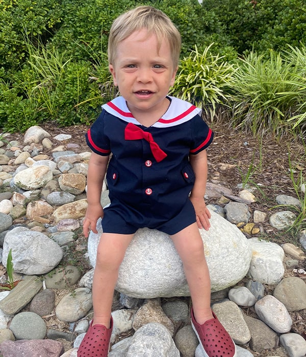 Stem cell recipient Austin Mares sitting on a rock