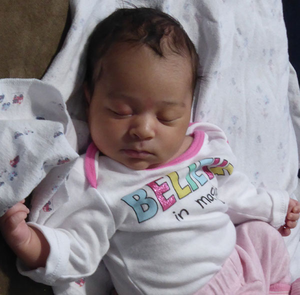 newborn baby laying on couch