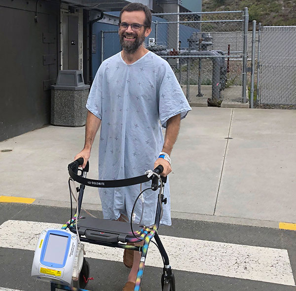 Man in hospital gown with walker