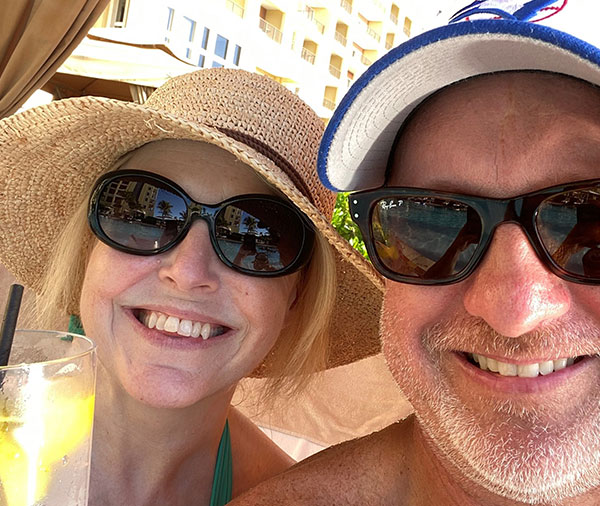 Smiling couple in hats and sunglasses in Aruba