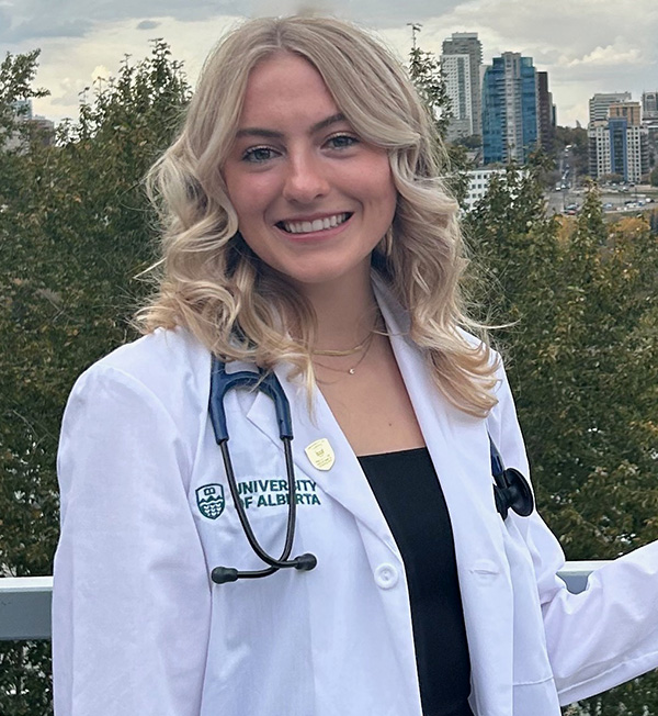 Payton H wearing a white lab coat with a stelthoscope