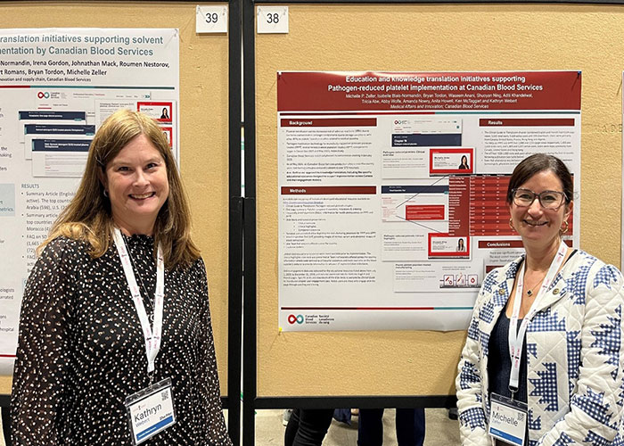 Dr. Kathryn Webert and Dr. Michelle Zellers standing in front of a poster