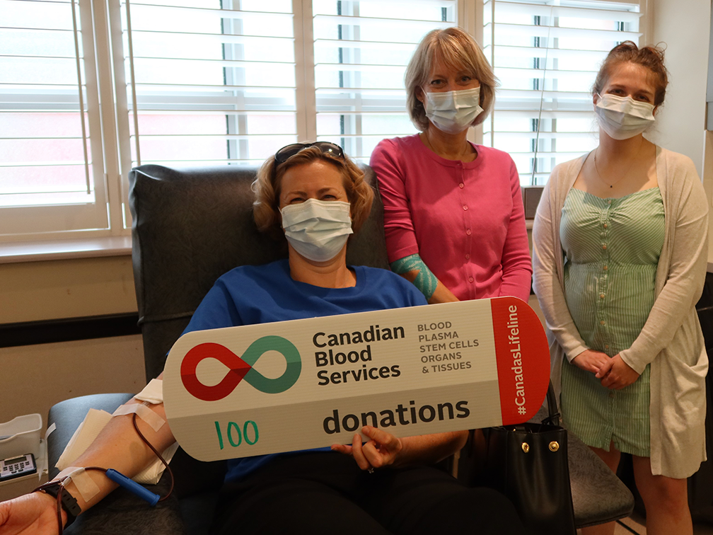 RBC Blood donor in donor chair with Canadian blood services staff