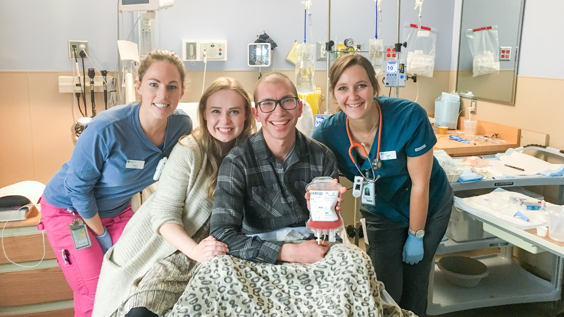 Lauren and members of Michael’s medical team with him as he holds  precious donor stem cells just prior to receiving them for his lifesaving transplant on October 24, 2018