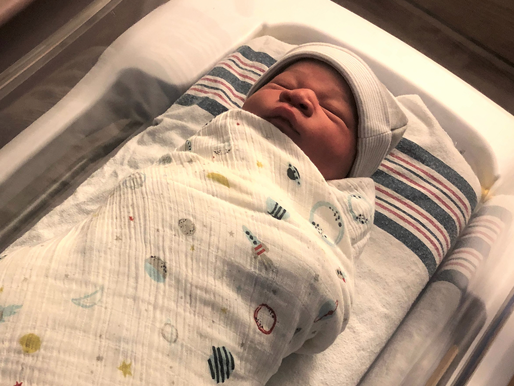 Newborn Jakobe Greenidge sleeps in hospital swaddled in a blanket.