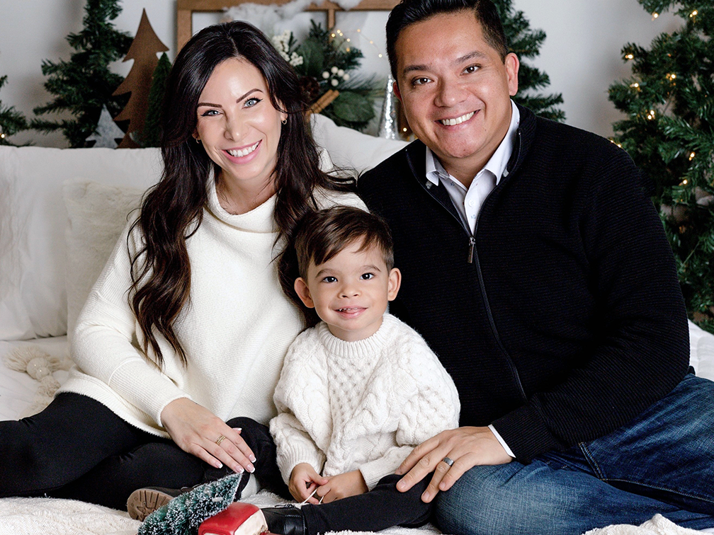 Mother, father and son with Christmas tree and decorations