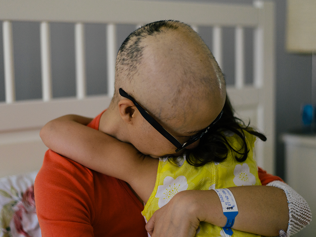 Stem cell recipient and advocate Mai Duong hugs her daughter