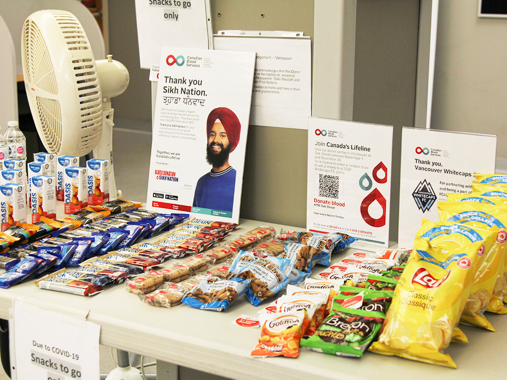 a table full of snacks in a canadian blood services donor centre